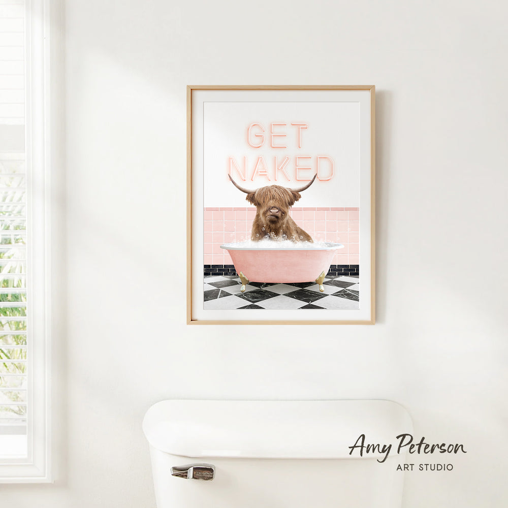 A framed poster with a cartoon image of a dog sitting in a bathtub, with the text "GET NAKED" written on it.