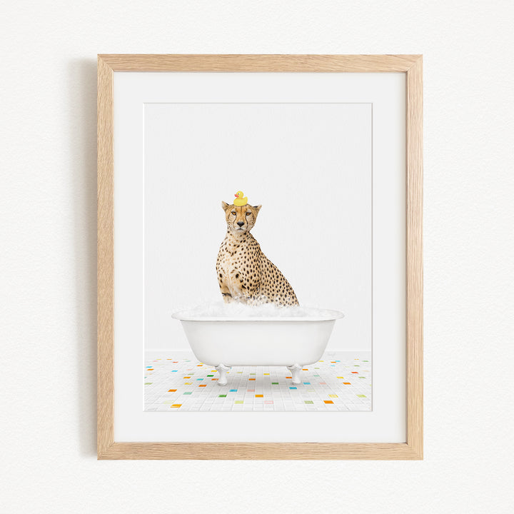 A cheetah wearing a yellow crown is sitting in a white bathtub filled with bubbles, surrounded by a colorful tiled floor.