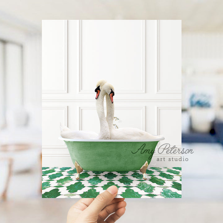 a person holding up a picture of a swan in a bathtub