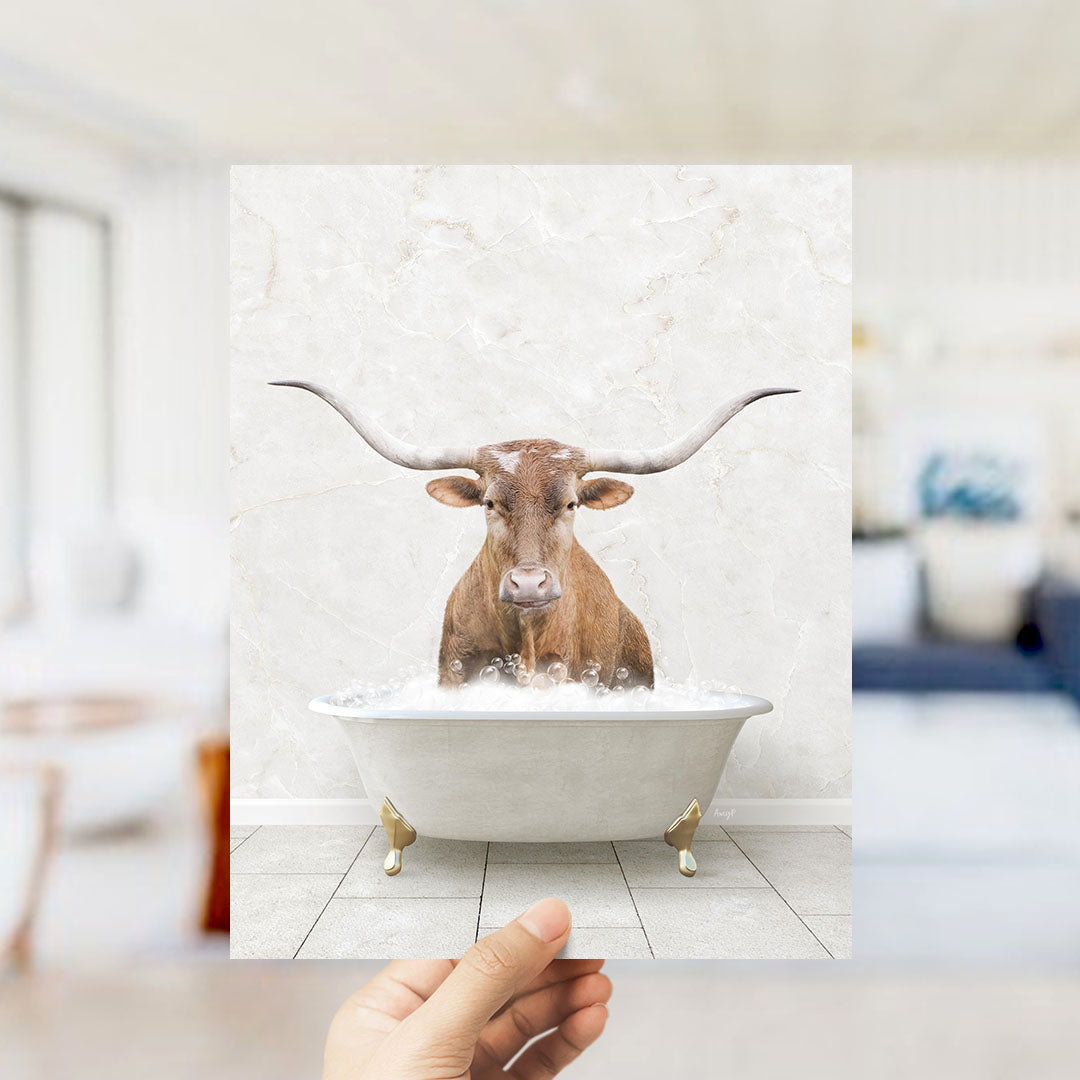 A brown bull with long horns is sitting in a white bathtub filled with water, creating a whimsical and playful scene.