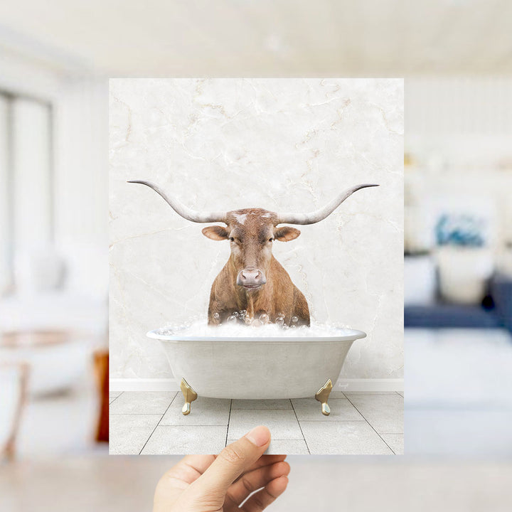 A brown bull with long horns is sitting in a white bathtub filled with water, creating a whimsical and playful scene.