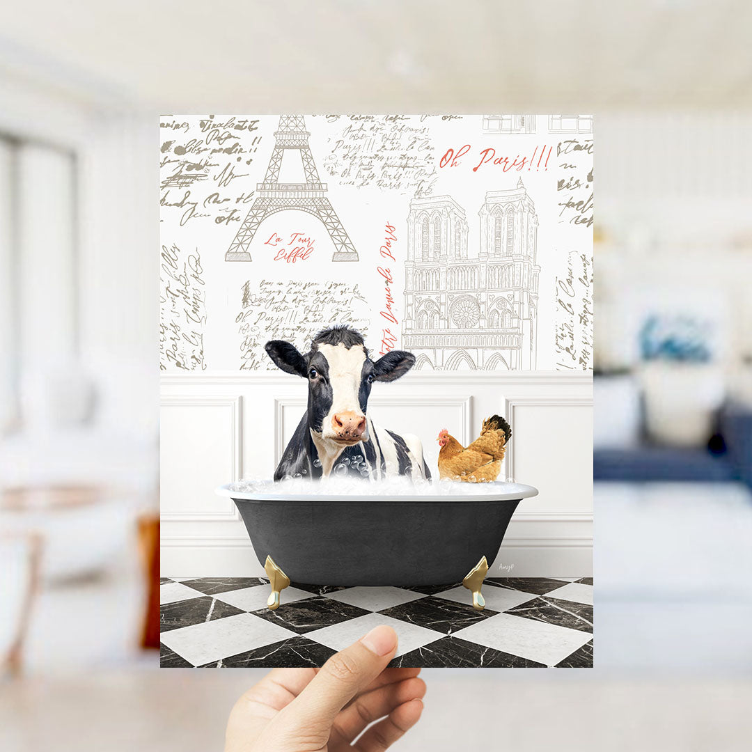 A cow is sitting in a bathtub filled with water, with a chicken standing nearby, in a room with a Paris-themed wallpaper.