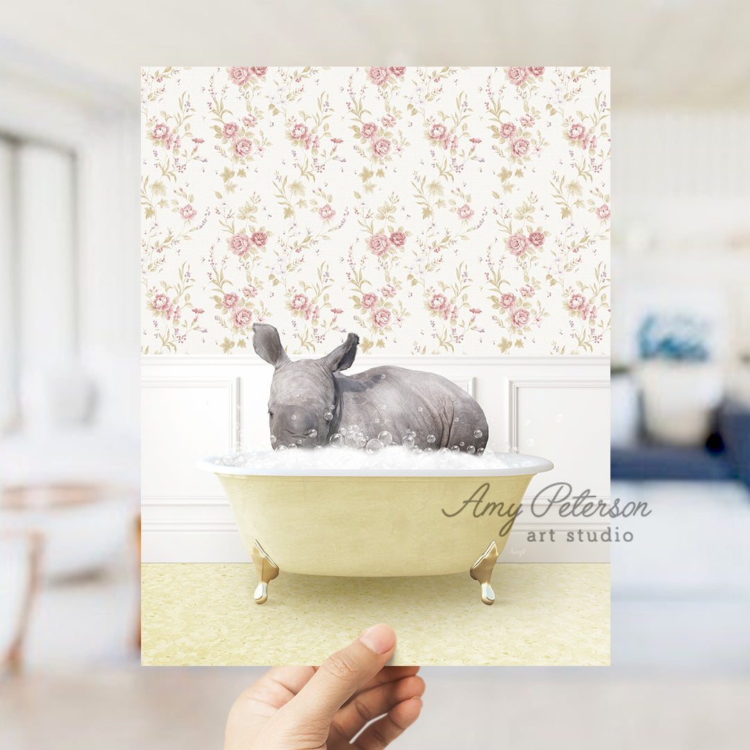 a hand holding up a card with a rhino in a bathtub