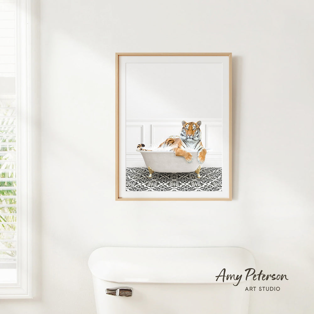 A framed print of a tiger sitting in a bathtub is hanging on a white wall in a bathroom.