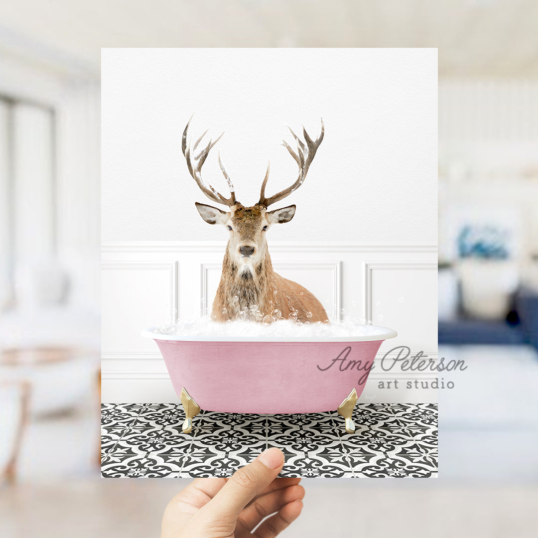 a hand holding a card with a picture of a deer in a bathtub