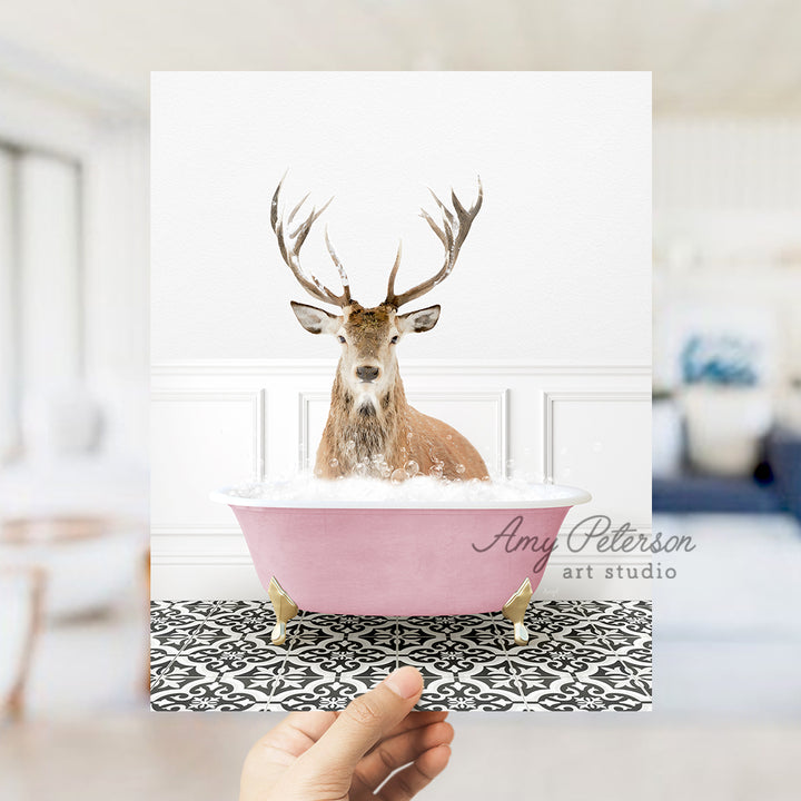 a hand holding a card with a picture of a deer in a bathtub