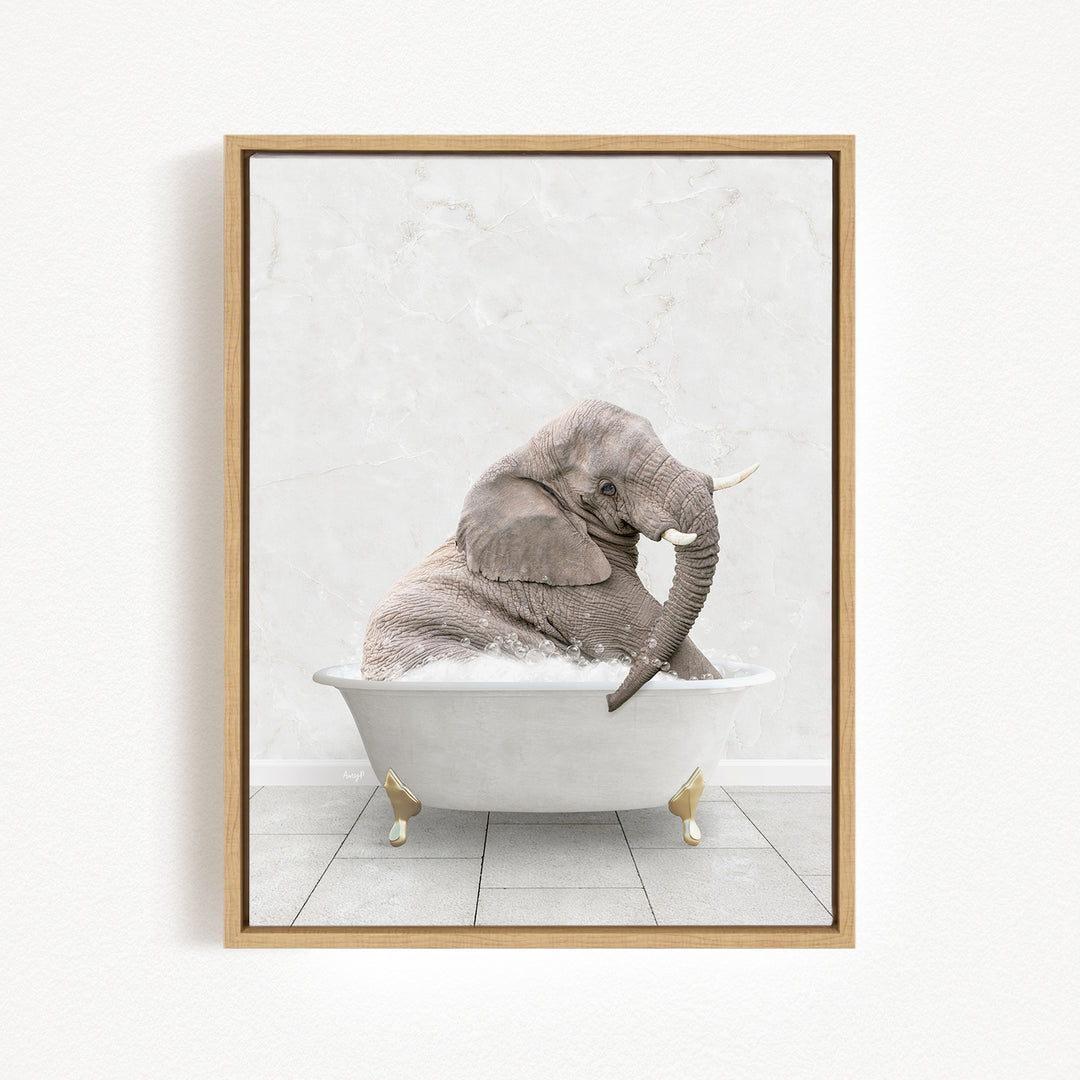 A gray elephant is sitting in a white bathtub, with its trunk raised and appearing to be enjoying the bath.