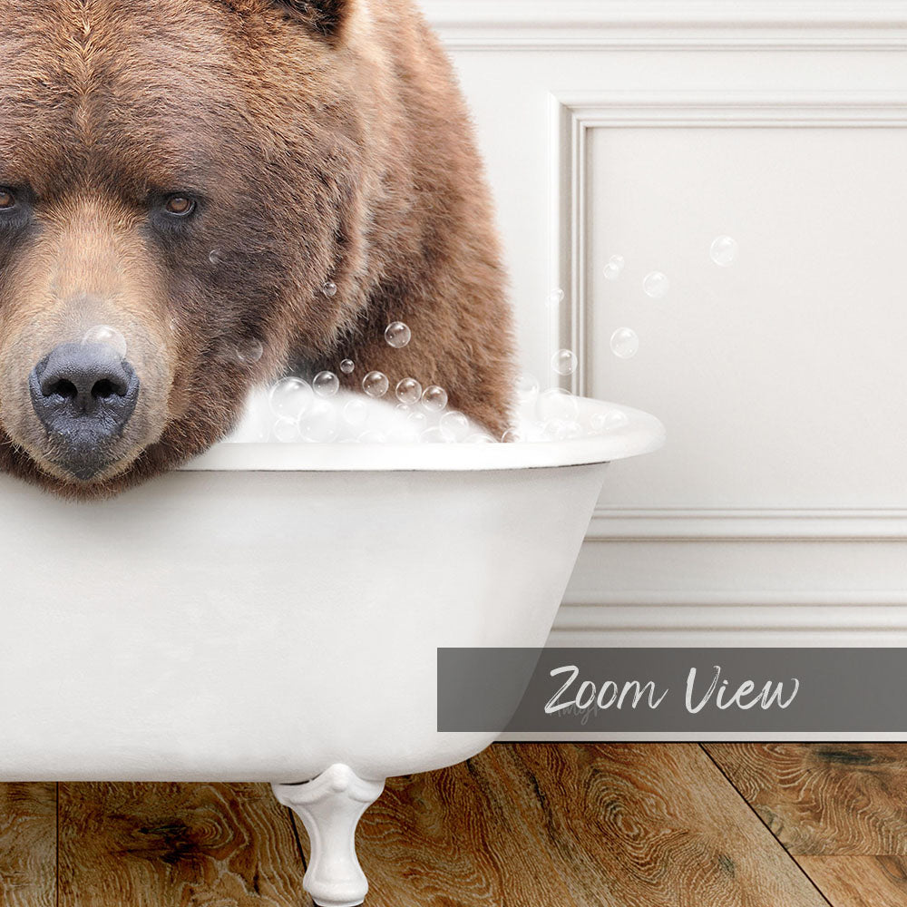 A large brown bear is sitting in a white bathtub filled with bubbles, creating a whimsical and amusing scene.