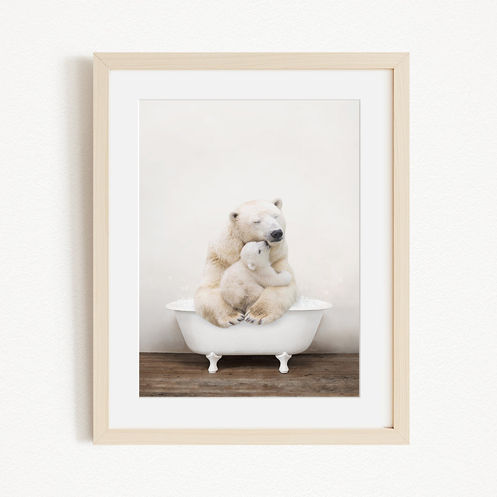 A polar bear and its cub sitting together in a white bathtub, with the bear appearing to be hugging the cub.