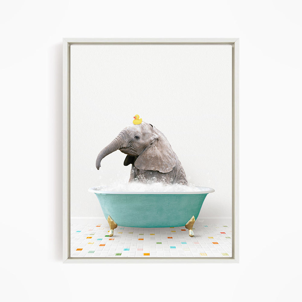 A gray elephant is sitting in a green bathtub, with a yellow rubber duck perched on its head.