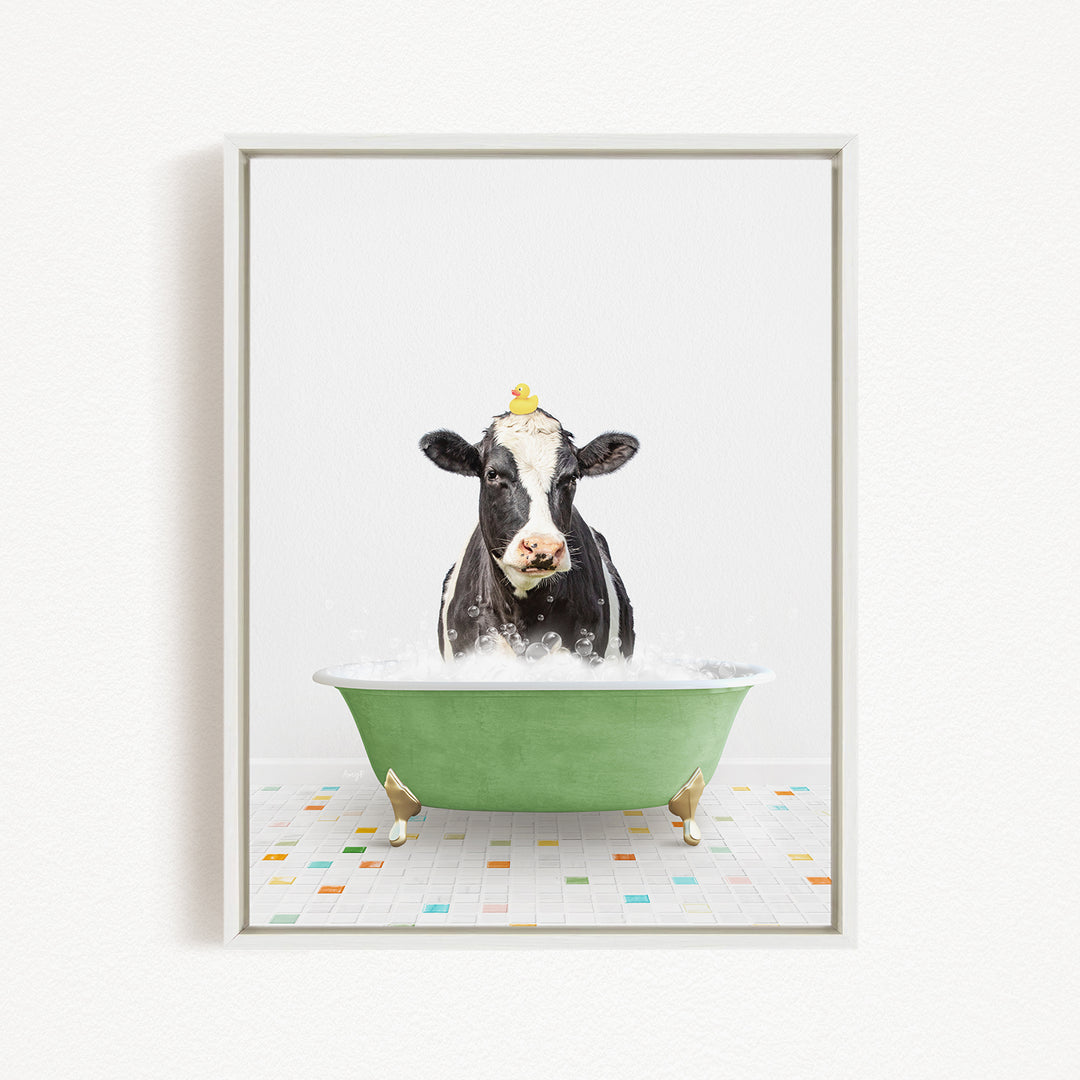 A black and white cow is sitting in a green bathtub filled with bubbles, with ducks floating on its head.
