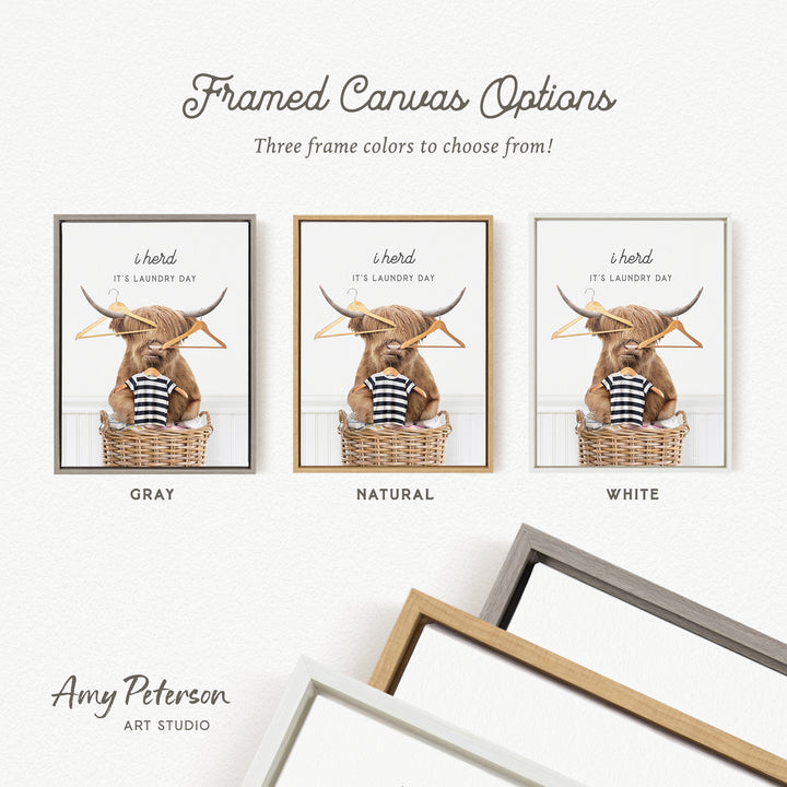 The image is a framed canvas option featuring a framed image of a Highland cow with a basket of laundry. The canvas options include three different frame colors: gray, natural, and white.