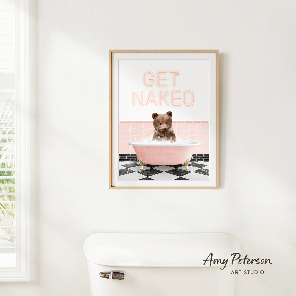 A framed print with a bear sitting in a pink bathtub, with the text "GET NAKED" displayed above it.