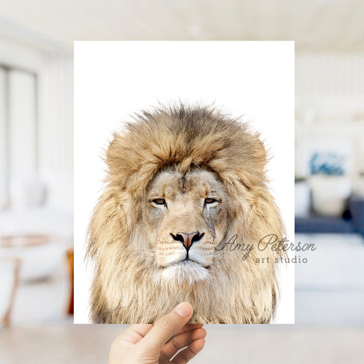 a hand holding up a picture of a lion