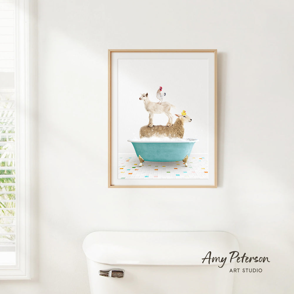 A framed print of a sheep standing on a bathtub is hanging on a white wall.