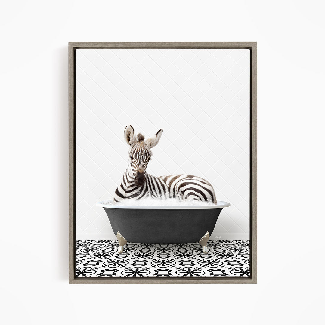 A zebra is sitting in a bathtub filled with water, surrounded by a black and white patterned floor.