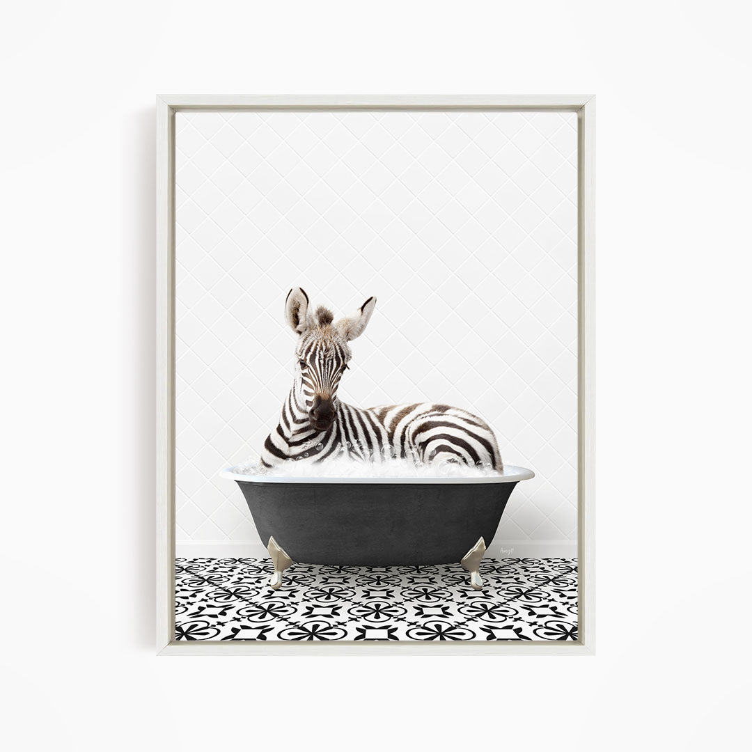 A zebra is sitting in a bathtub filled with water, surrounded by a black and white patterned floor.