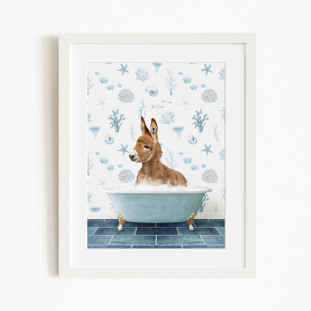 A donkey is sitting in a bathtub filled with water, surrounded by a blue and white ocean-themed wallpaper.