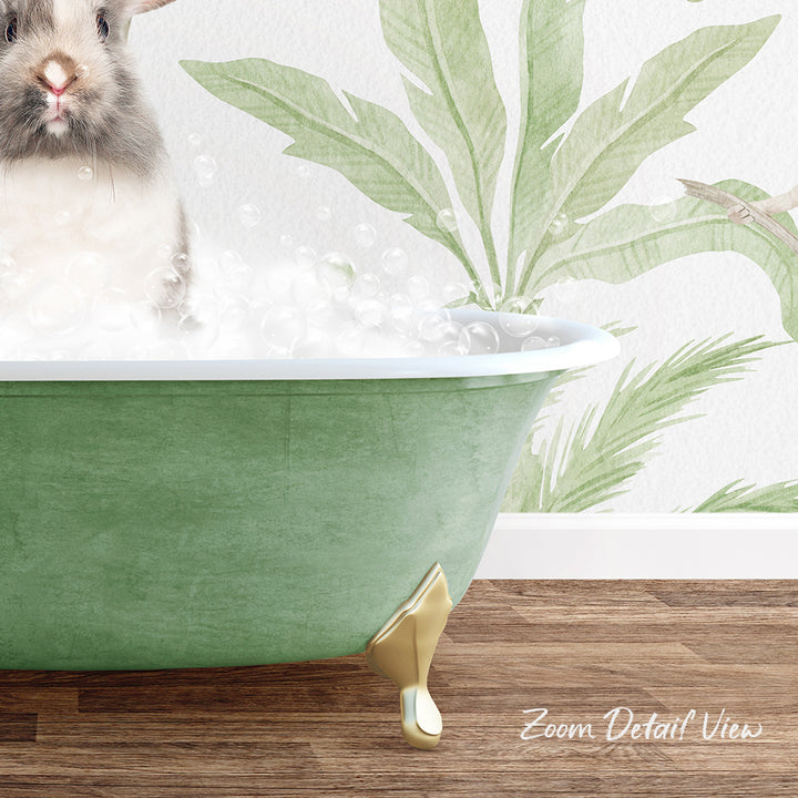 A small rabbit is sitting in a green bathtub filled with bubbles, with a tropical plant mural in the background.