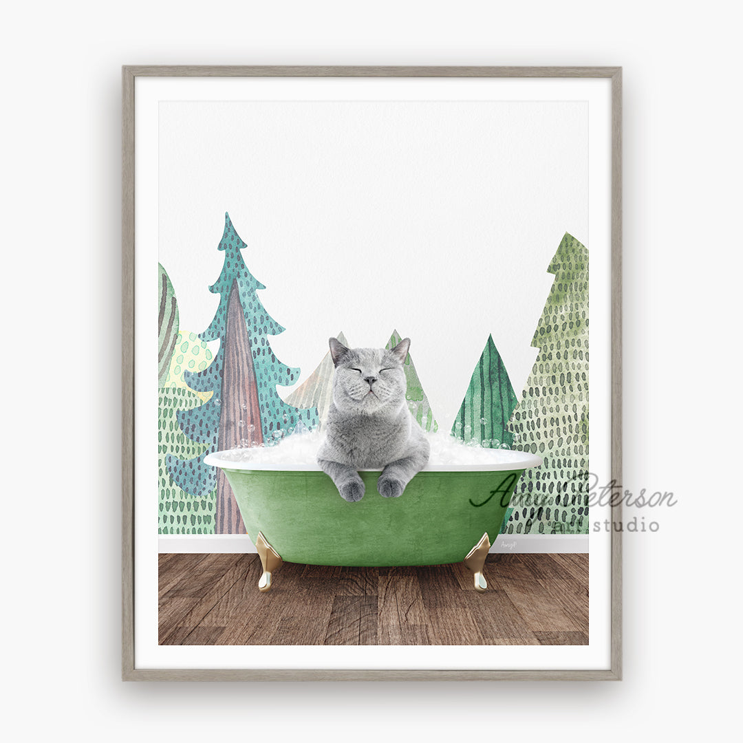 a cat sitting in a green bathtub with trees in the background