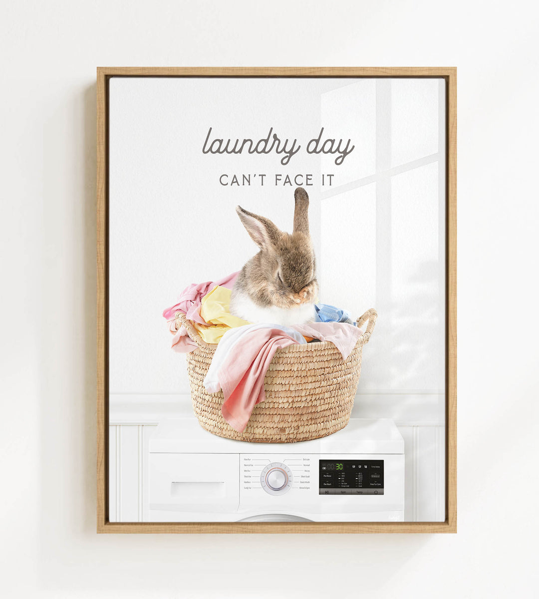 A rabbit sitting in a basket filled with laundry, with the text "laundry day can't face it" above the image.