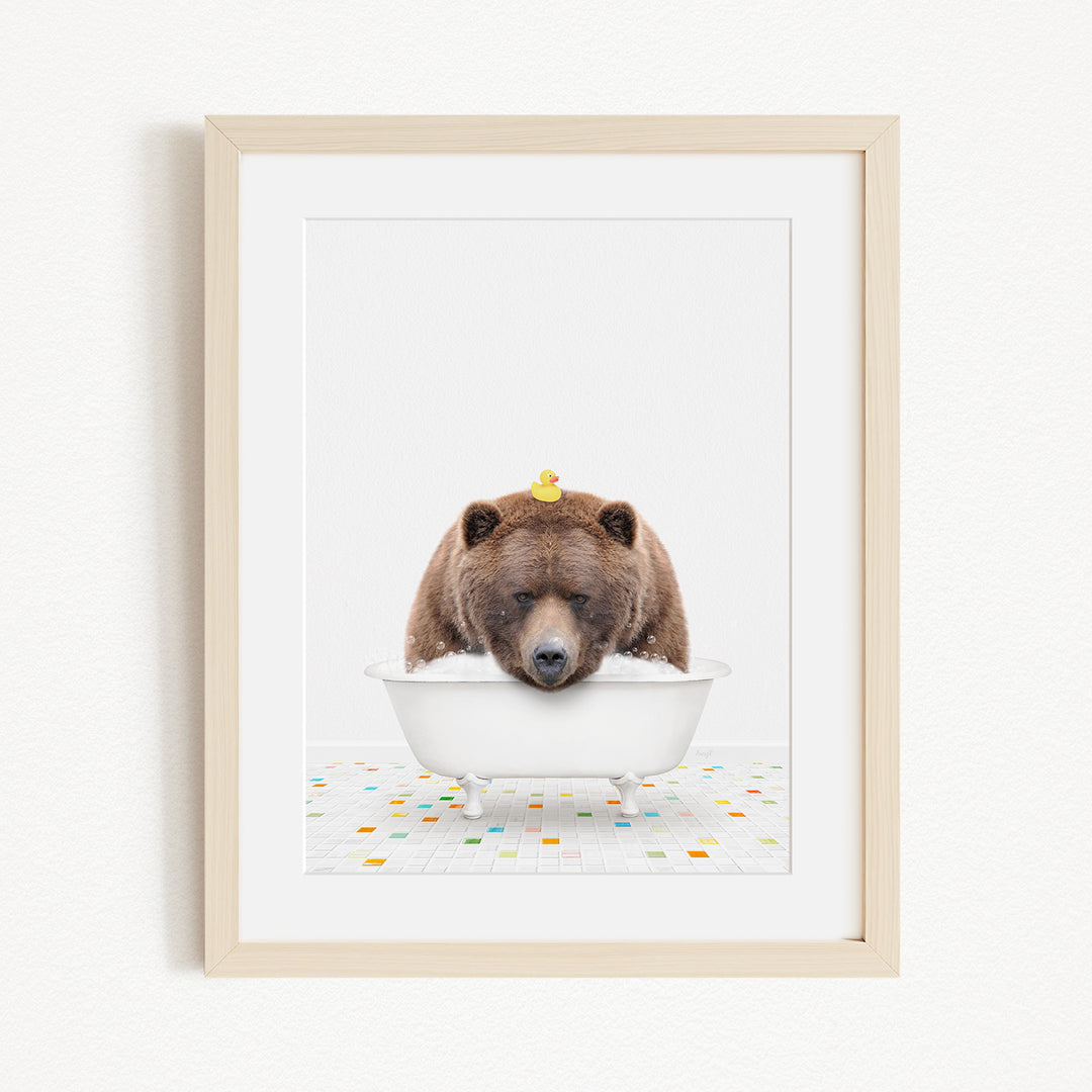 A brown bear is sitting in a white bathtub, with a yellow rubber duck perched on its head.