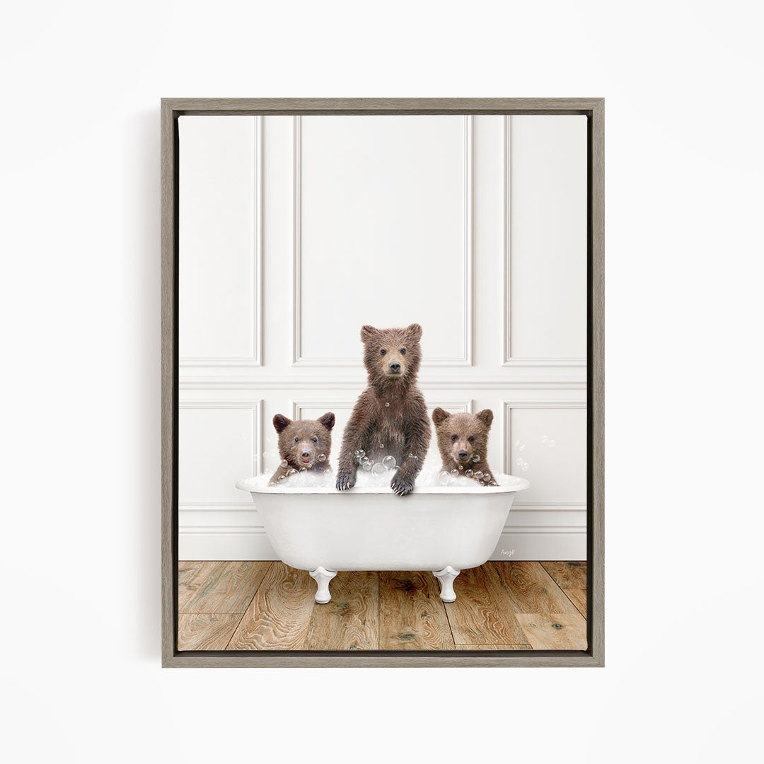 Three adorable brown bears sitting in a white bathtub, enjoying a relaxing bath together.