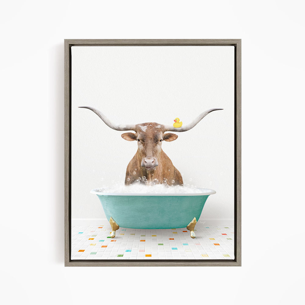 A brown cow with long horns is sitting in a green bathtub, with a yellow rubber duck perched on its head.
