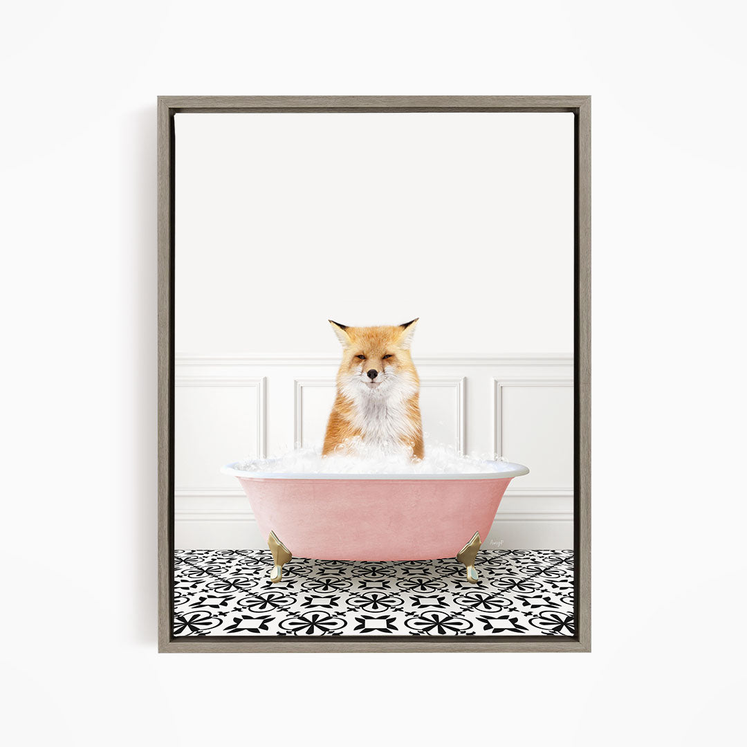 A red fox sitting in a pink bathtub filled with bubbles, looking directly at the camera.