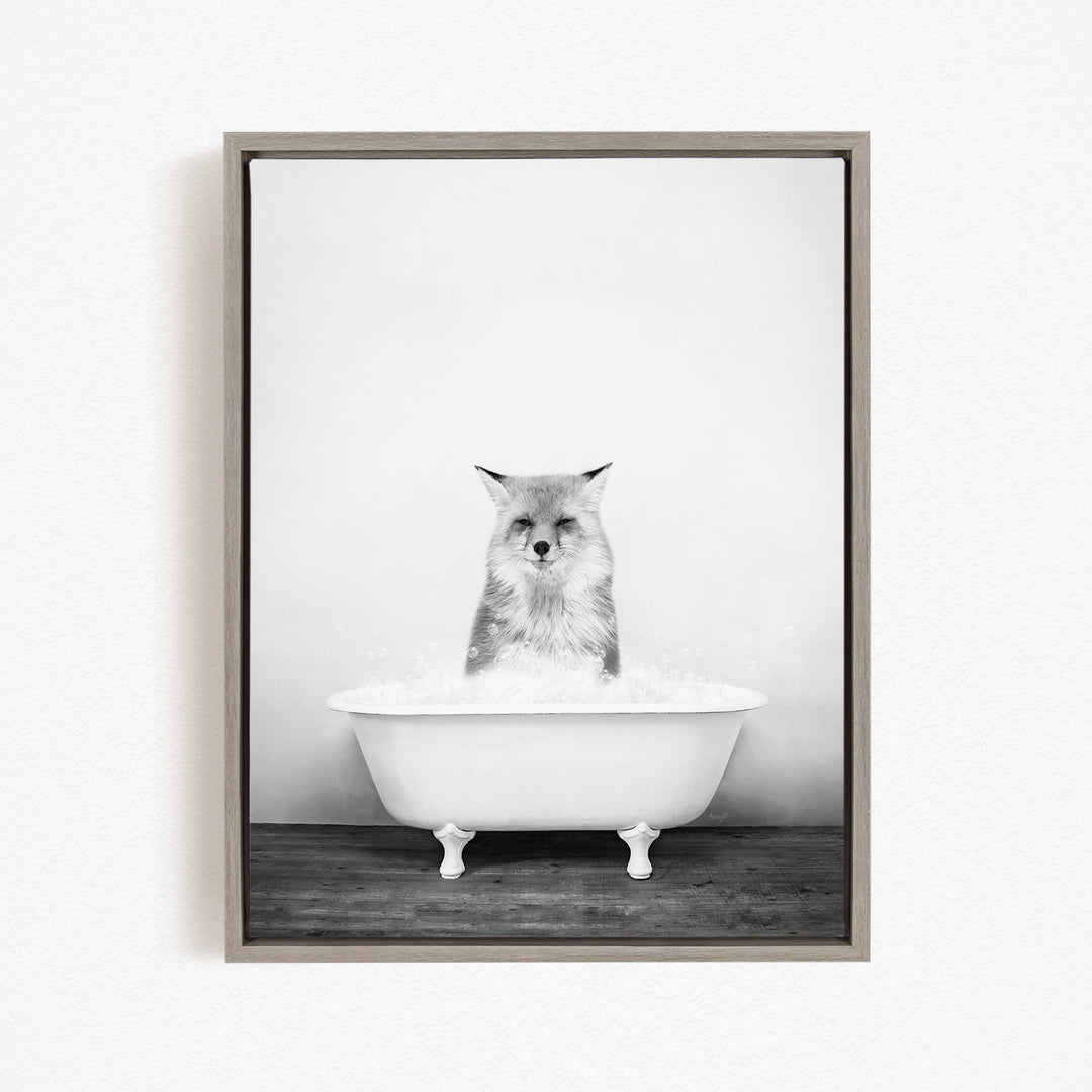 A cat sitting in a white bathtub filled with bubbles, looking directly at the camera.