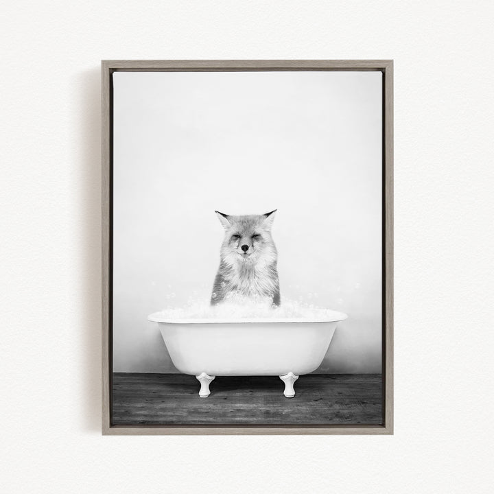A cat sitting in a white bathtub filled with bubbles, looking directly at the camera.