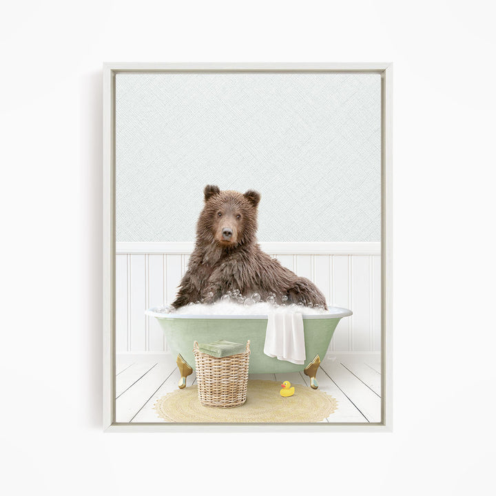 A brown bear sitting in a green bathtub filled with water, surrounded by a yellow rubber duck and a basket.