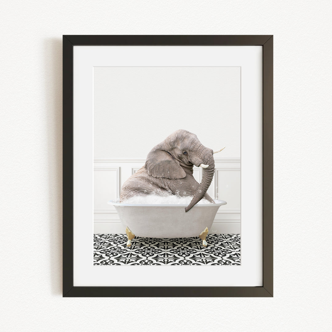 A gray elephant sitting in a white bathtub filled with water, surrounded by a black and white patterned rug.