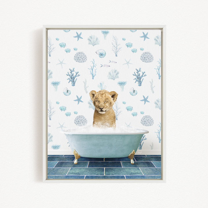 A young lion cub is sitting in a blue bathtub filled with water, surrounded by a pattern of seashells, starfish, and other marine life.