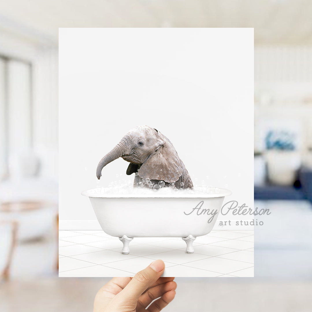 a person holding up a card with an elephant in a bathtub