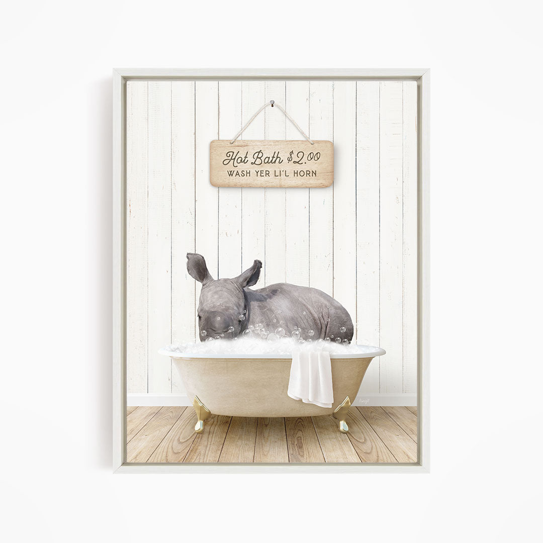 A rhinoceros is sitting in a bathtub filled with water, with a sign above it that reads "Hot Bath $2.00 WASH TER LITT LILL HORN".