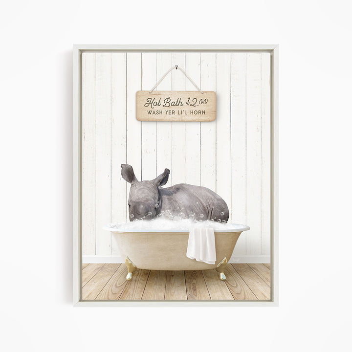 A rhinoceros is sitting in a bathtub filled with water, with a sign above it that reads "Hot Bath $2.00 WASH TER LITT LILL HORN".