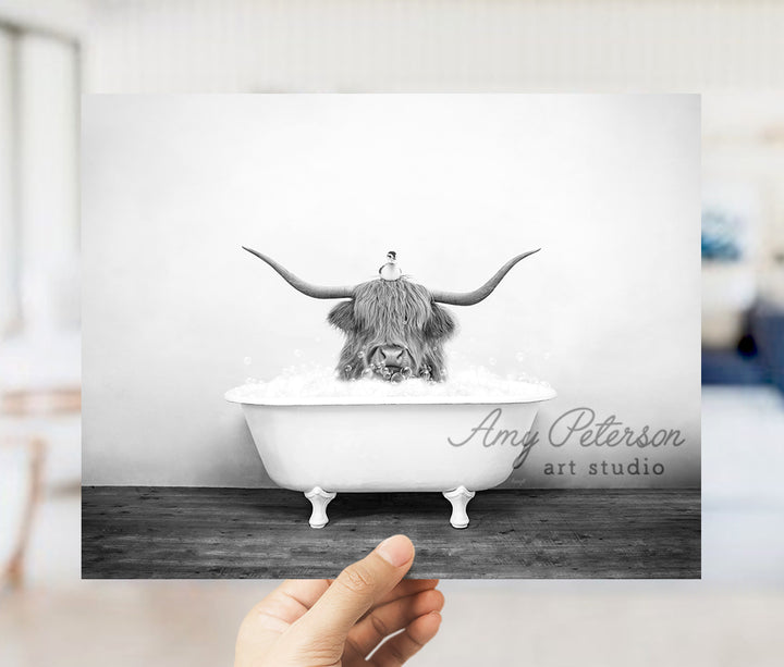 a black and white photo of a bull in a bathtub