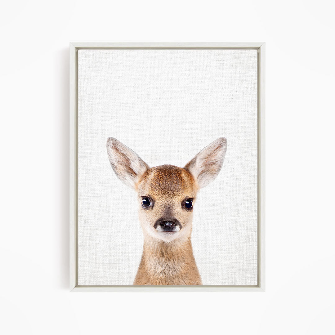 A framed print of a deer's head with large, alert ears and a curious expression.
