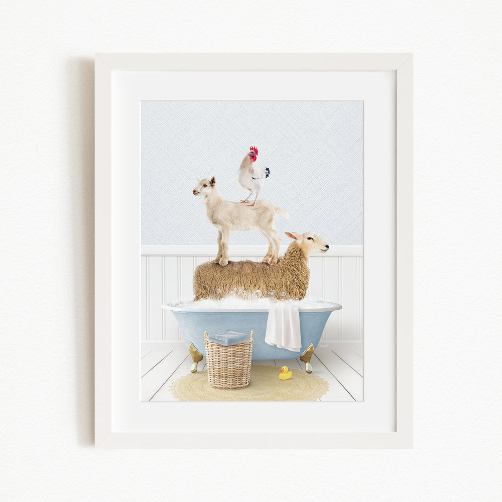 A framed image depicting a goat standing on top of a sheep in a bathtub, with a rooster perched on the sheep's back.