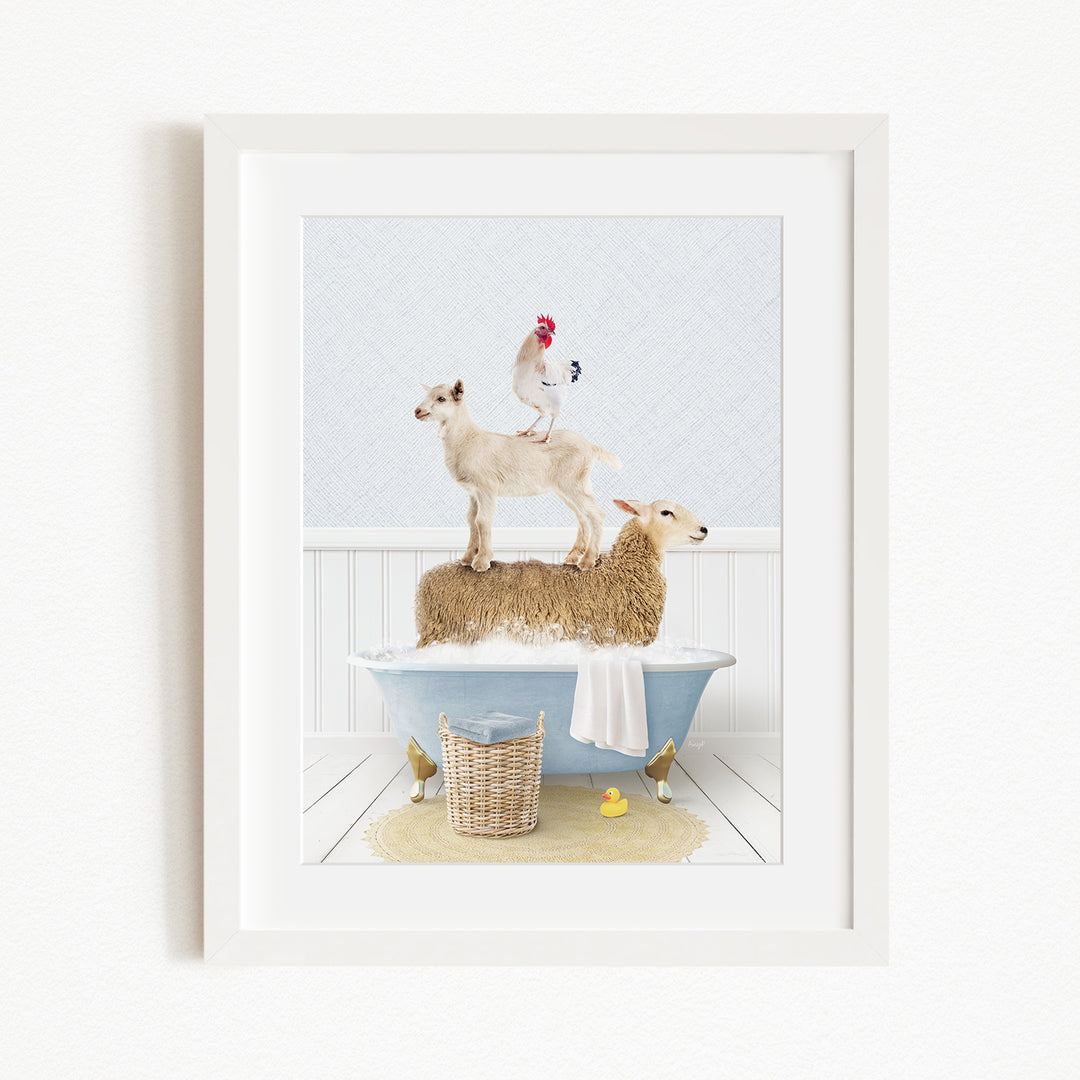 A framed image depicting a goat standing on top of a sheep in a bathtub, with a rooster perched on the sheep's back.