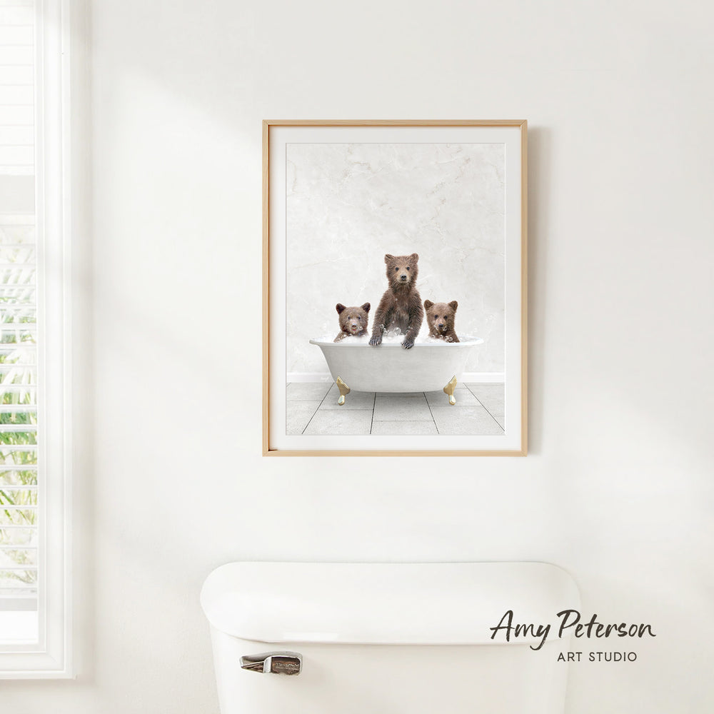 A framed image of three bears sitting in a bathtub, with one bear sitting in the center and the other two bears sitting on either side.