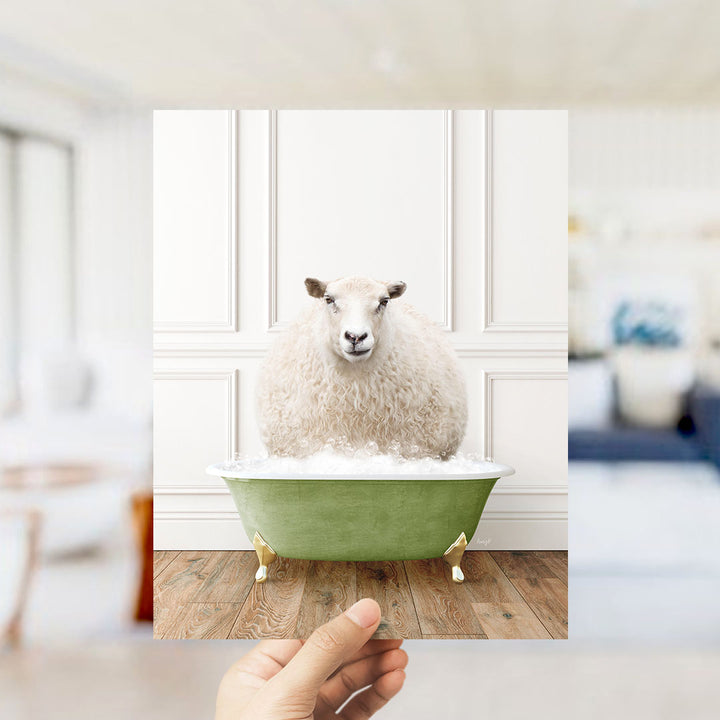 A fluffy white sheep sits in a green bathtub, surrounded by a blurred living room setting.