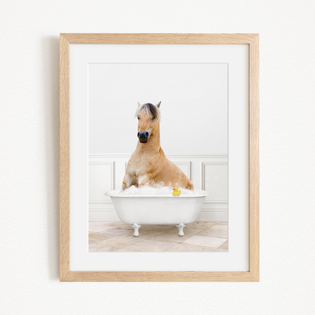 A brown horse sitting in a white bathtub filled with water, with a yellow rubber duck floating in the water.