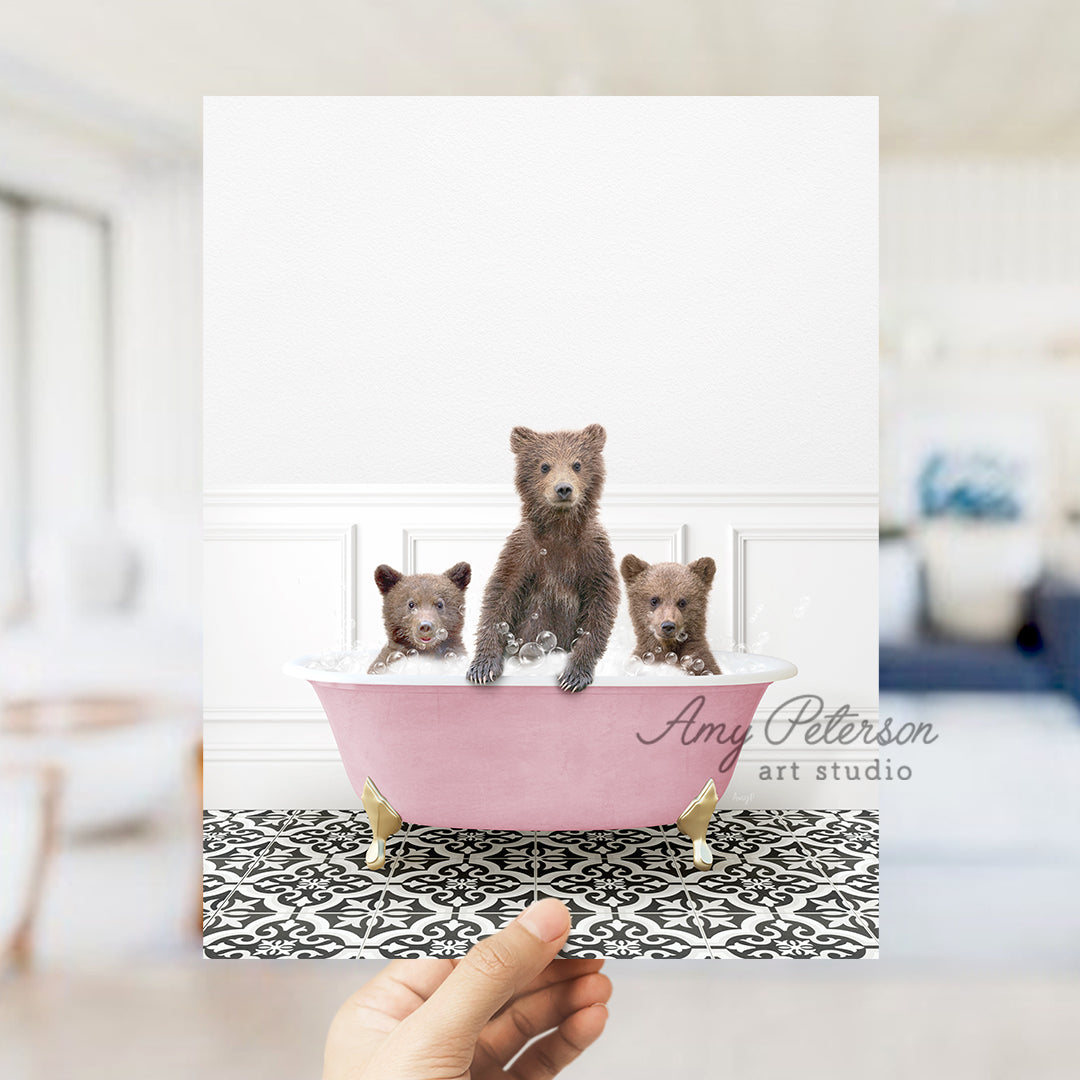 a person holding a card with three bears in a bathtub