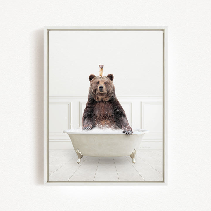 A brown bear sitting in a white bathtub, with a small bird perched on its head.