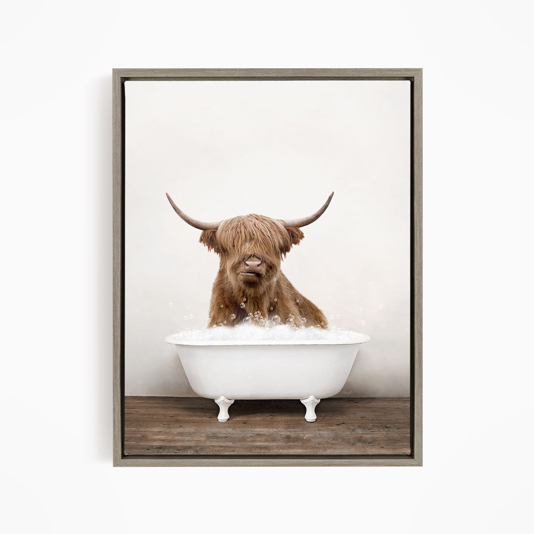 A brown cow with long horns is sitting in a white bathtub filled with water, creating a whimsical and humorous scene.