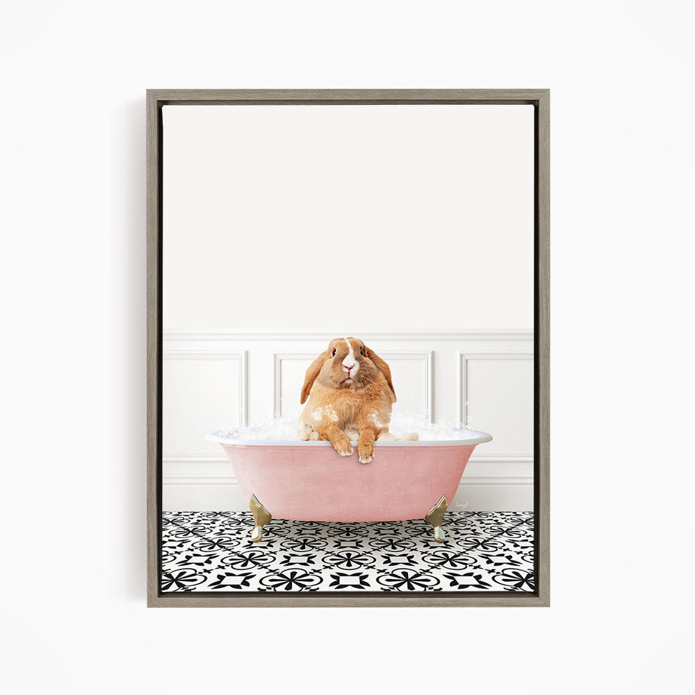 A brown rabbit sitting in a pink bathtub filled with bubbles, surrounded by a black and white patterned floor.