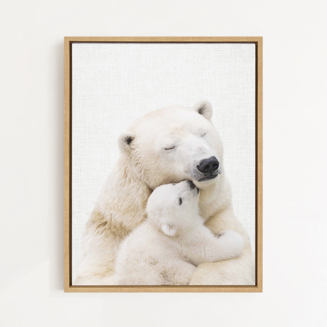 A mother polar bear tenderly embracing her cub in a serene, snowy landscape.