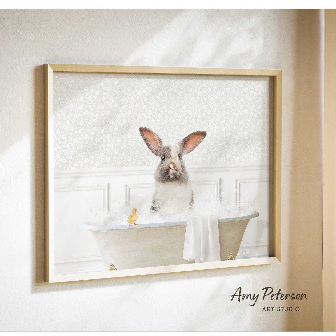 A gray rabbit sitting in a bathtub filled with bubbles, accompanied by a yellow duck.